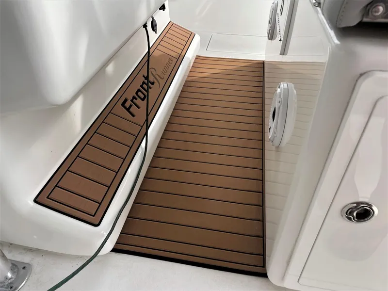 Slide: The Image of 2020 Front Runner 39 Center Console boat interior with brown deck matting. - 34