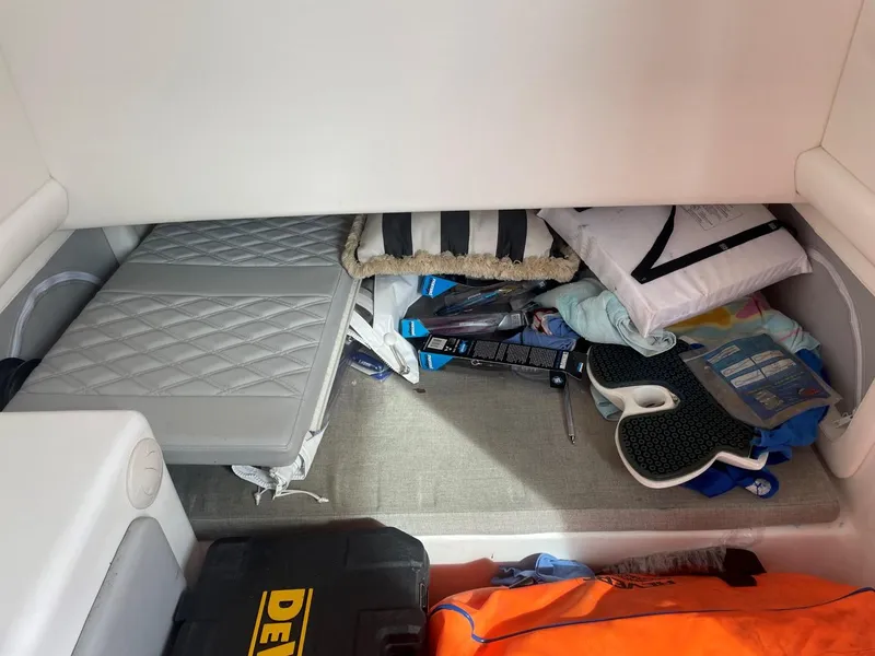 Slide: The Image of Storage compartment in a 2020 Front Runner 39 Center Console boat, with various items and equipment. - 49