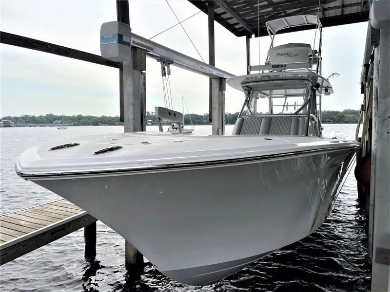 Slide: The Image of 2020 Front Runner 39 Center Console boat docked under a covered marina. - 9