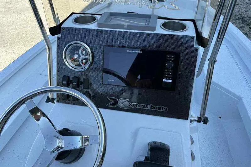 Slide: The Image of 2026 Xpress H20B boat dashboard with steering wheel and navigation display. - 10