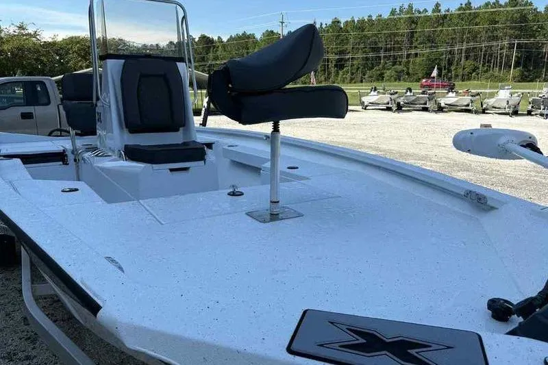 Slide: The Image of 2026 Xpress H20B boat with seating, displayed outdoors in a lot. - 13