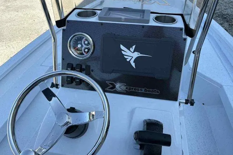 Slide: The Image of 2026 Xpress H20B boat dashboard with steering wheel and control panel. - 16
