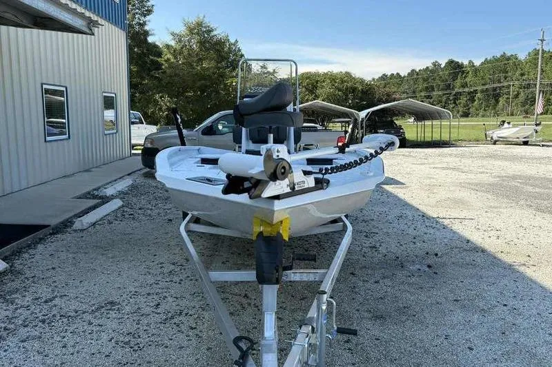 Slide: The Image of 2026 Xpress H20B boat on trailer in outdoor dealership lot. - 2