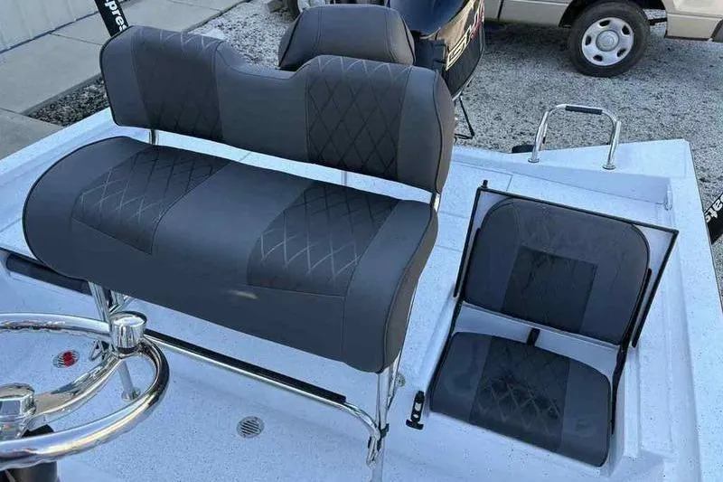 Slide: The Image of 2026 Xpress H20B boat interior with dual seating and steering wheel. - 5