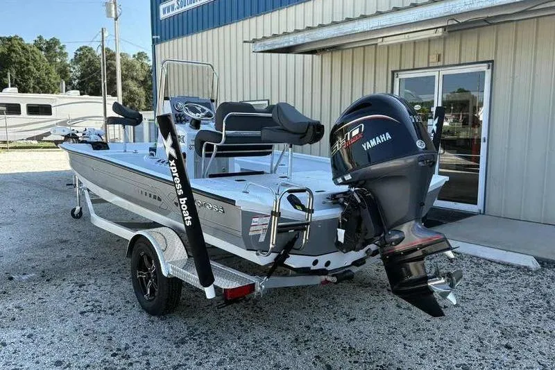 Slide: The Image of 2026 Xpress H20B boat with Yamaha motor on trailer outside a building. - 6