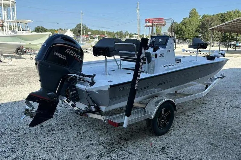 Slide: The Image of 2026 Xpress H20B boat with Yamaha engine on trailer in outdoor setting. - 7