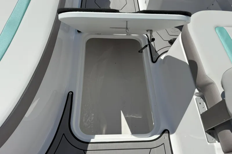 Slide: The Image of Open storage compartment on 2026 Hurricane SunDeck Sport 185 OB boat interior. - 13