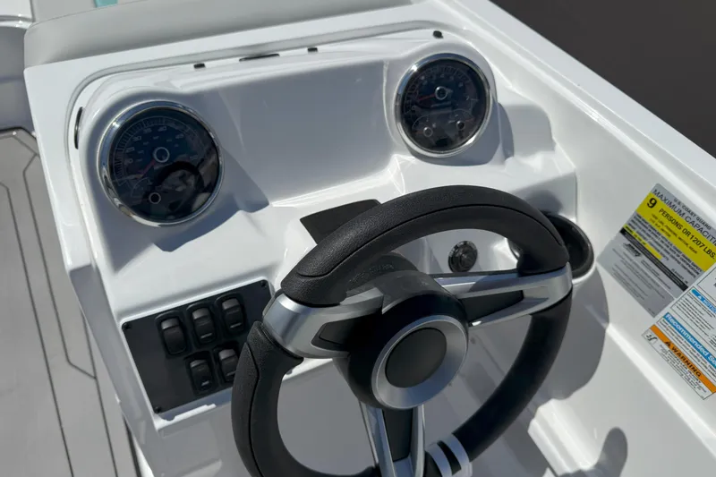 Slide: The Image of 2026 Hurricane SunDeck Sport 185 OB boat dashboard with steering wheel and gauges. - 9