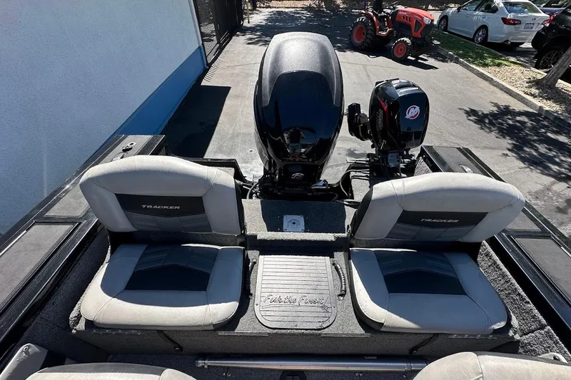 Slide: The Image of 2018 Tracker Targa V-19 Combo boat interior with dual seats and outboard motors. - 12