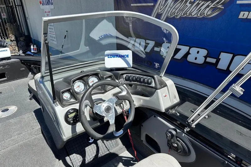Slide: The Image of 2018 Tracker Targa V-19 Combo boat dashboard with Lowrance electronics and steering wheel. - 16