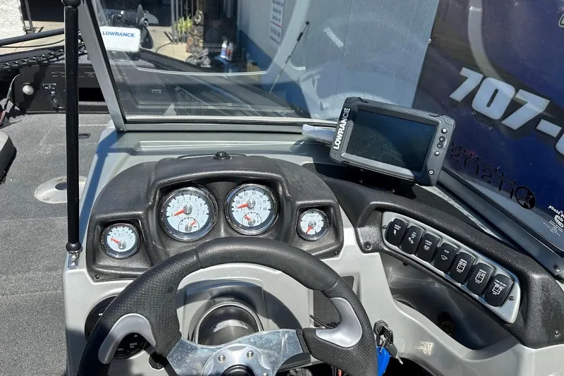 Slide: The Image of 2018 Tracker Targa V-19 Combo dashboard with gauges and Lowrance fishfinder. - 17