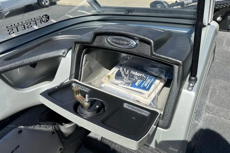 Slide: The Image of 2018 Tracker Targa V-19 Combo boat dashboard with open storage compartment. - 22