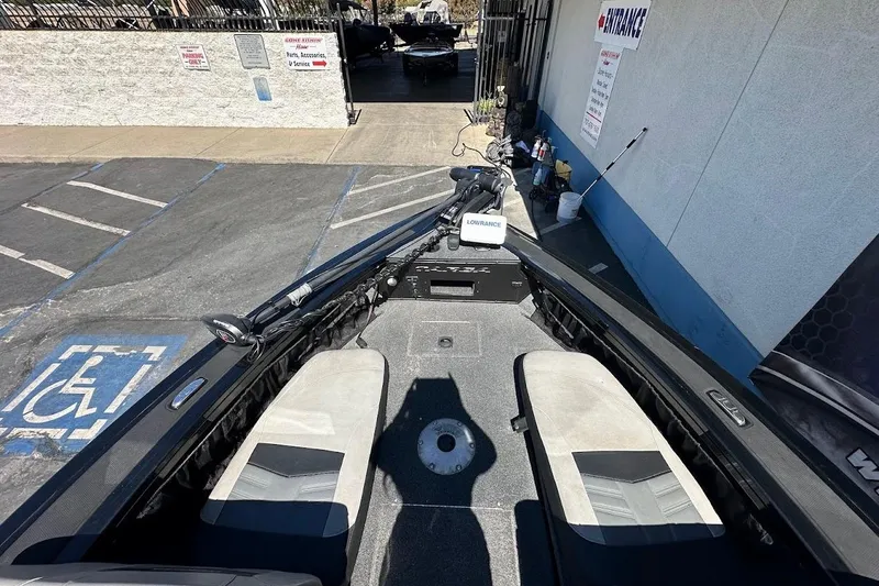 Slide: The Image of 2018 Tracker Targa V-19 Combo boat parked near a building entrance. - 24