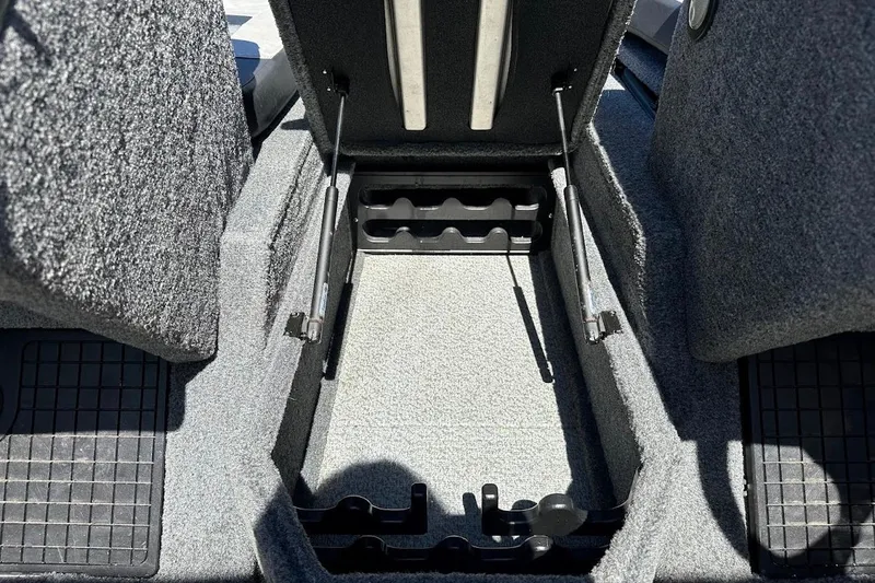 Slide: The Image of 2018 Tracker Targa V-19 Combo boat storage compartment with carpeted interior and hydraulic lifts. - 29