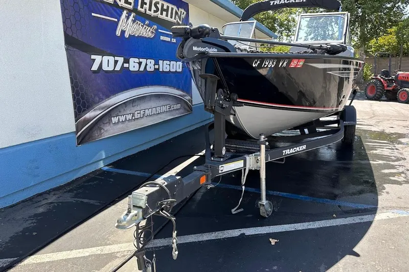 Slide: The Image of 2018 Tracker Targa V-19 Combo boat on trailer, parked outside marine shop. - 3