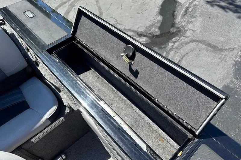 Slide: The Image of Open storage compartment in 2018 Tracker Targa V-19 Combo boat, showing interior details. - 31