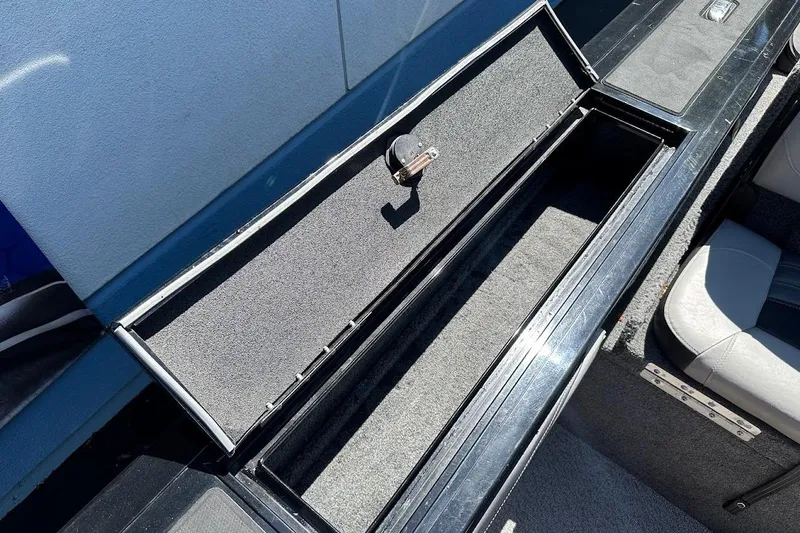 Slide: The Image of 2018 Tracker Targa V-19 Combo boat storage compartment, open and empty. - 32