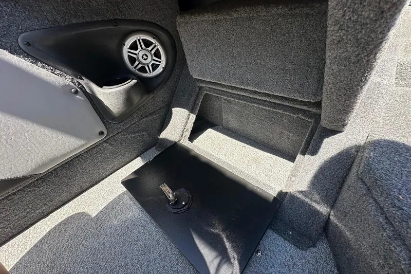 Slide: The Image of Interior of 2018 Tracker Targa V-19 Combo boat with speaker and carpeted storage. - 33