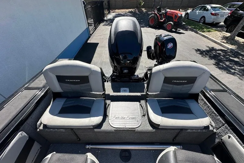 Slide: The Image of 2018 Tracker Targa V-19 Combo boat interior with dual seats and outboard motor. - 34