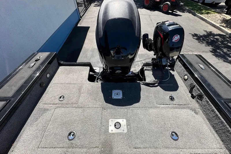 Slide: The Image of 2018 Tracker Targa V-19 Combo boat with dual outboard motors, parked on pavement. - 35