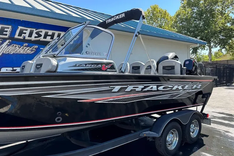 Slide: The Image of 2018 Tracker Targa V-19 Combo boat on trailer, parked outside a marine shop. - 5