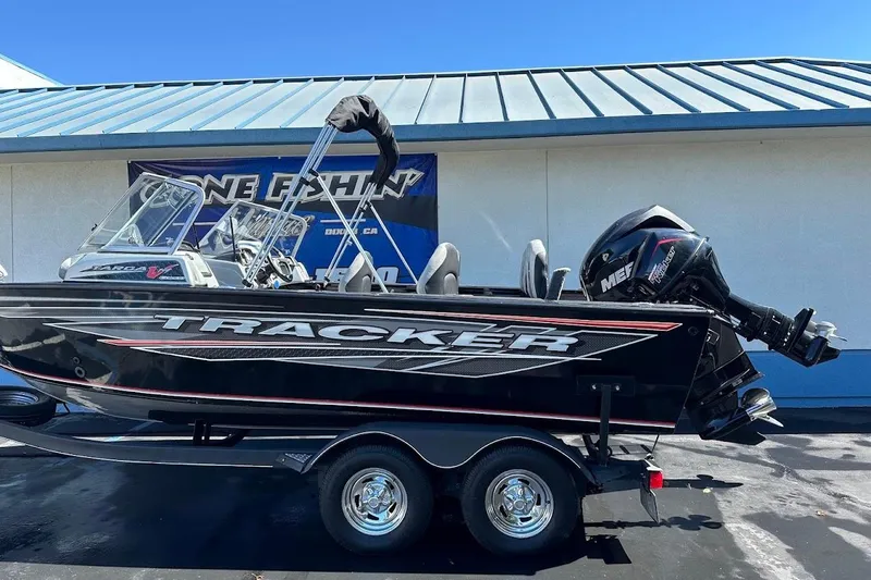 Slide: The Image of 2018 Tracker Targa V-19 Combo boat on trailer, displayed outdoors. - 6