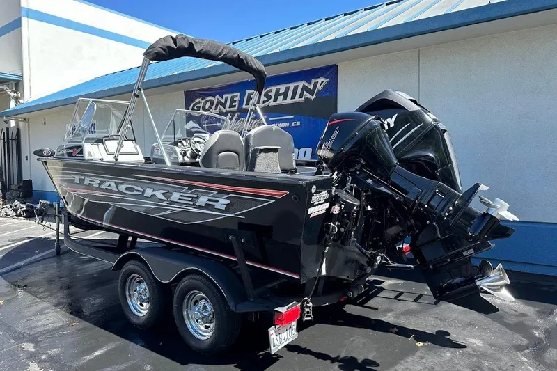 Slide: The Image of 2018 Tracker Targa V-19 Combo boat on trailer, parked outside a building. - 7