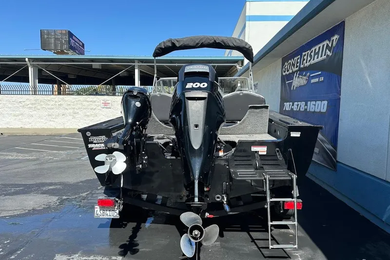 Slide: The Image of 2018 Tracker Targa V-19 Combo boat with powerful 200 HP engine, parked outdoors. - 8