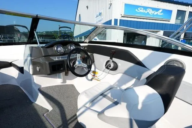 Slide: The Image of 2013 Four Winns H190 boat interior with steering wheel and dashboard, near Sea Ray building. - 10