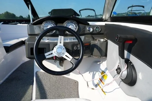 Slide: The Image of 2013 Four Winns H190 boat dashboard with steering wheel and control panel. - 11
