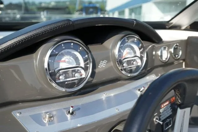 Slide: The Image of Dashboard of a 2013 Four Winns H190 boat with detailed gauges and controls. - 12