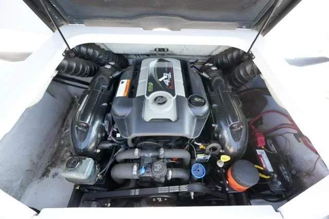 Slide: The Image of 2013 Four Winns H190 engine compartment, showcasing a well-maintained marine engine. - 14