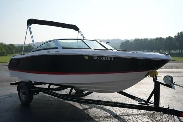 Slide: The Image of 2013 Four Winns H190 boat on trailer, parked outdoors. - 2