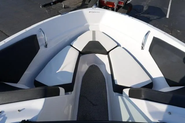Slide: The Image of 2013 Four Winns H190 boat interior with cushioned seating and sleek design. - 8