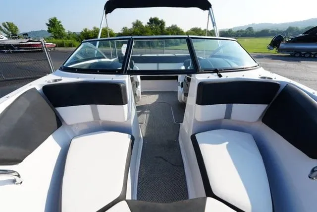 Slide: The Image of 2013 Four Winns H190 boat interior with black and white seating, open deck, and windshield. - 9