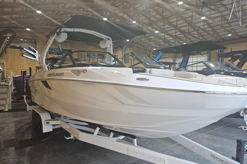 Slide: The Image of 2024 Centurion Fi23 boat displayed indoors on a trailer. - 3