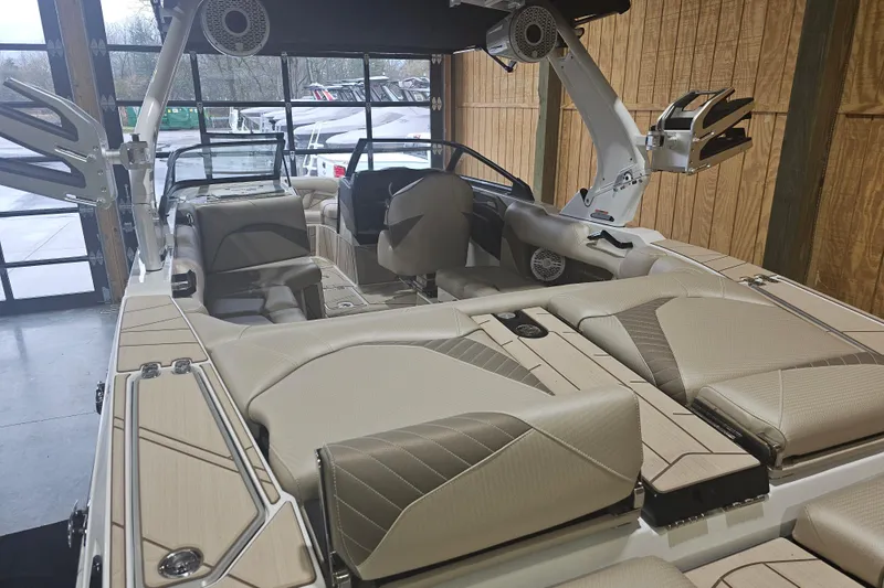 Slide: The Image of 2024 Centurion Fi23 boat interior with beige seating and modern design features. - 5