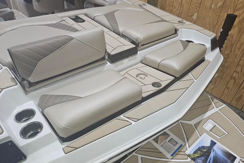 Slide: The Image of 2024 Centurion Fi23 boat interior with beige seating and cup holders. - 6