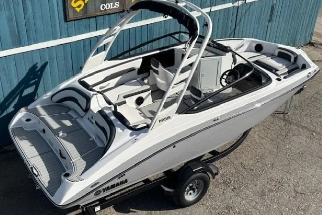 Slide: The Image of 2026 Yamaha Boats 195S on trailer, sleek design, white exterior, modern interior. - 5