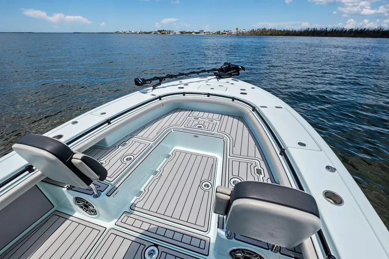 Slide: The Image of 2020 Barker Boatworks 26 Open on calm water, showcasing spacious deck and seating. - 11