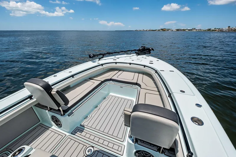Slide: The Image of 2020 Barker Boatworks 26 Open on calm water, showcasing spacious deck and seating. - 13