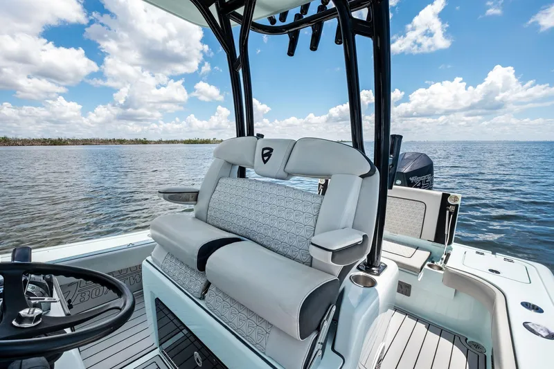 Slide: The Image of 2020 Barker Boatworks 26 Open on water, featuring sleek seating and steering console. - 18