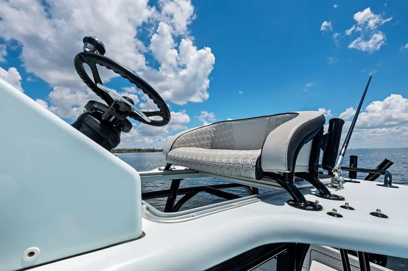 Slide: The Image of 2020 Barker Boatworks 26 Open helm with stylish seating under a bright blue sky. - 21
