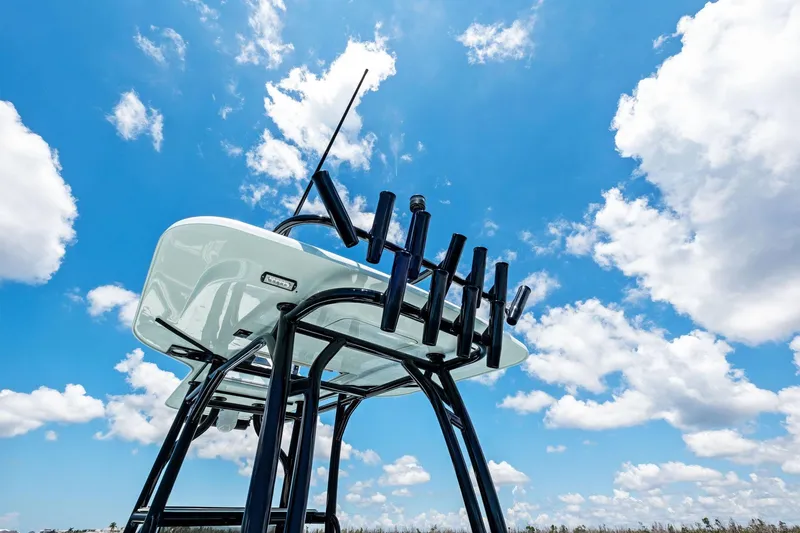 Slide: The Image of Barker Boatworks 26 Open 2020 model against a bright blue sky with clouds. - 24
