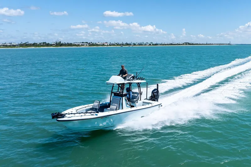 Slide: The Image of 2020 Barker Boatworks 26 Open cruising on clear blue water under a sunny sky. - 32