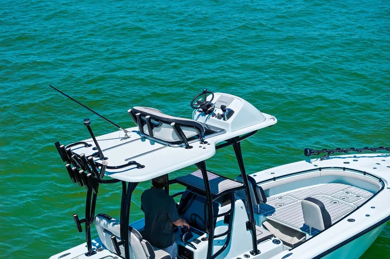 Slide: The Image of 2020 Barker Boatworks 26 Open on turquoise water, featuring elevated helm and fishing rod holders. - 8
