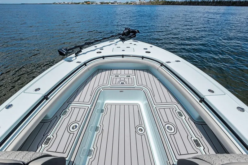 Slide: The Image of 2020 Barker Boatworks 26 Open, spacious deck, sleek design, on calm water. - 15