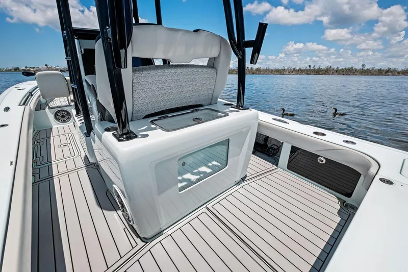 Slide: The Image of 2020 Barker Boatworks 26 Open, sleek deck design, calm waters, clear sky. - 19