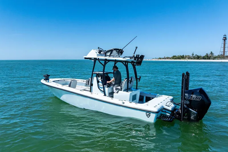 Slide: The Image of 2020 Barker Boatworks 26 Open on calm ocean near lighthouse. - 2