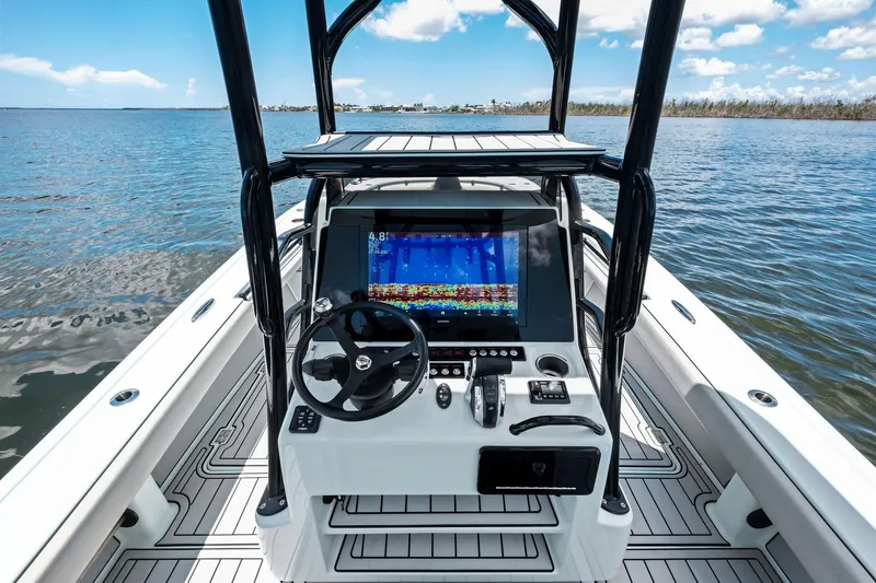 Slide: The Image of 2020 Barker Boatworks 26 Open console with navigation screen on calm water. - 20